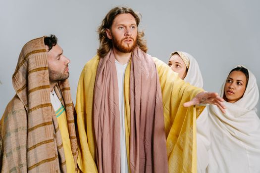A diverse group portrays a biblical scene, evoking traditional religious themes.