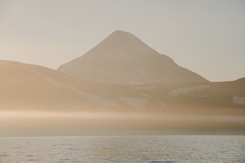 Free Tranquil view of a mist-covered mountain and body of water in Sakhalin, Russia. Stock Photo