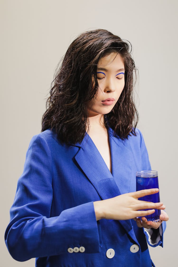 
Woman Wearing Blue Blazer Holding Drinking Glass