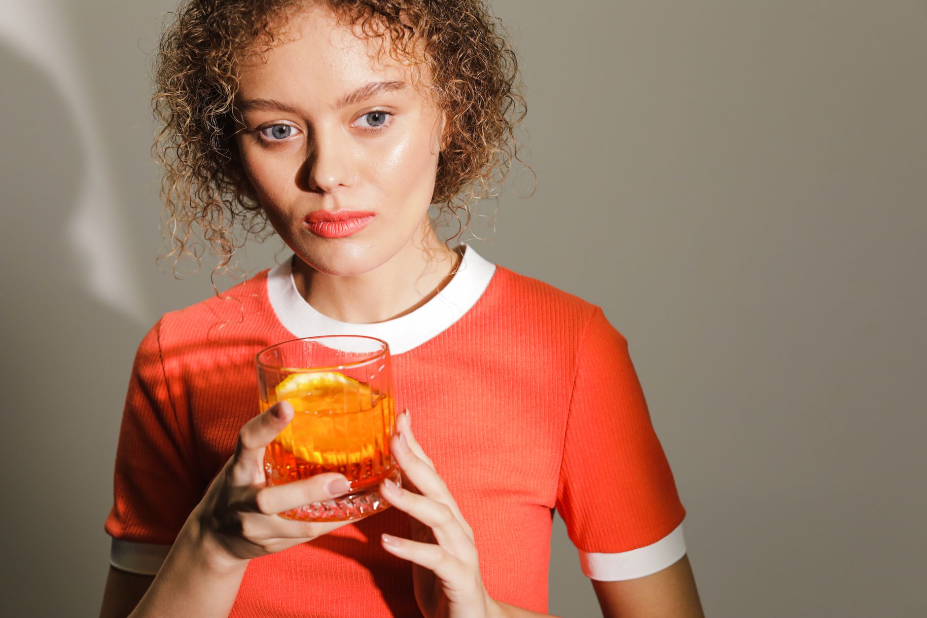 Warm fall Negroni cocktail with herbs and orange peel