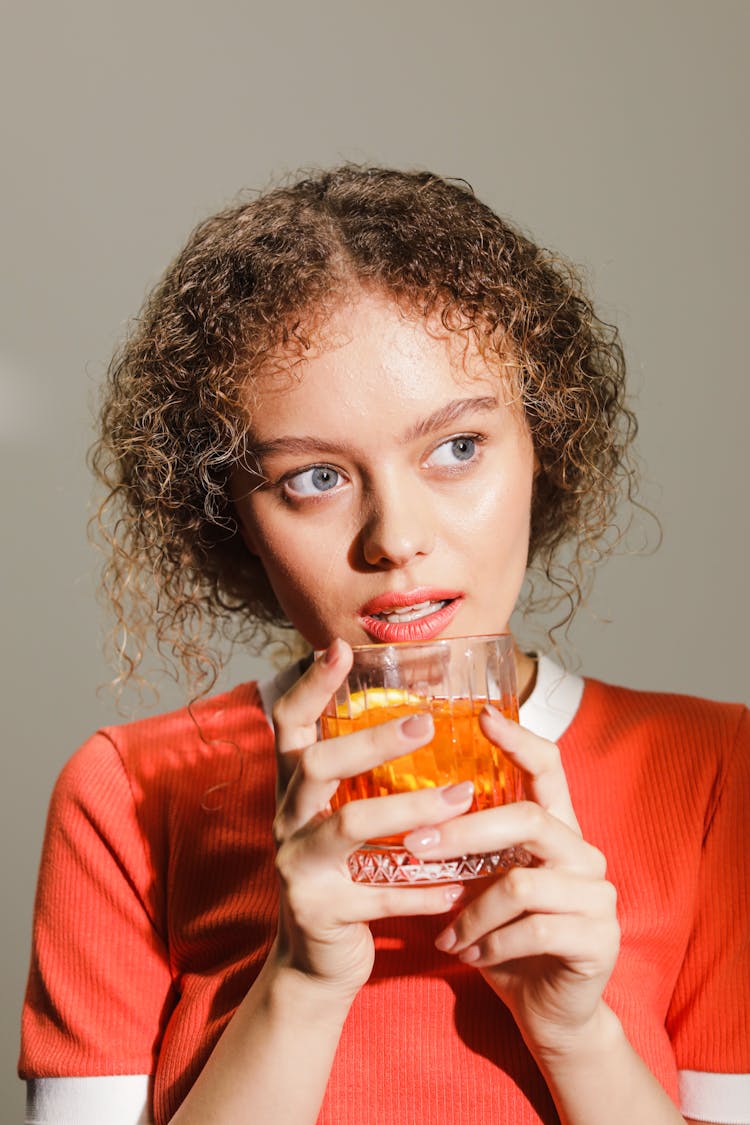 Woman Drinking A Negroni Cocktail Drink