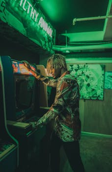 Man enjoying arcade game under vibrant neon lights inside a retro gaming space.