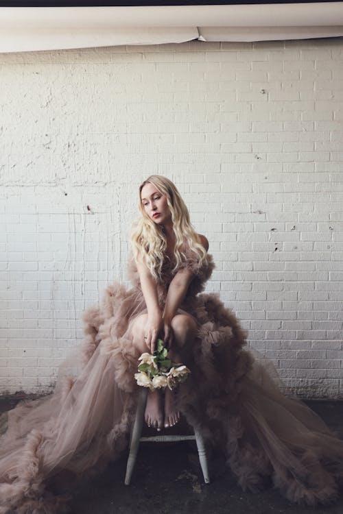 Woman in Tulle Dress Holding Bouquet of Flowers