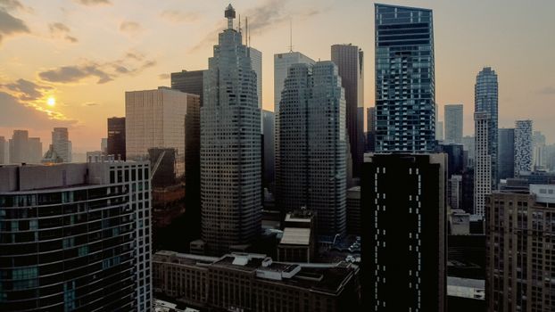A stunning aerial view of a city's skyscrapers during a golden hour sunset, capturing urban beauty and architectural design.