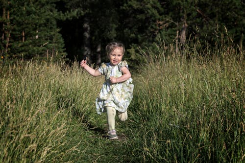  Little Girl Running on the Green Grass