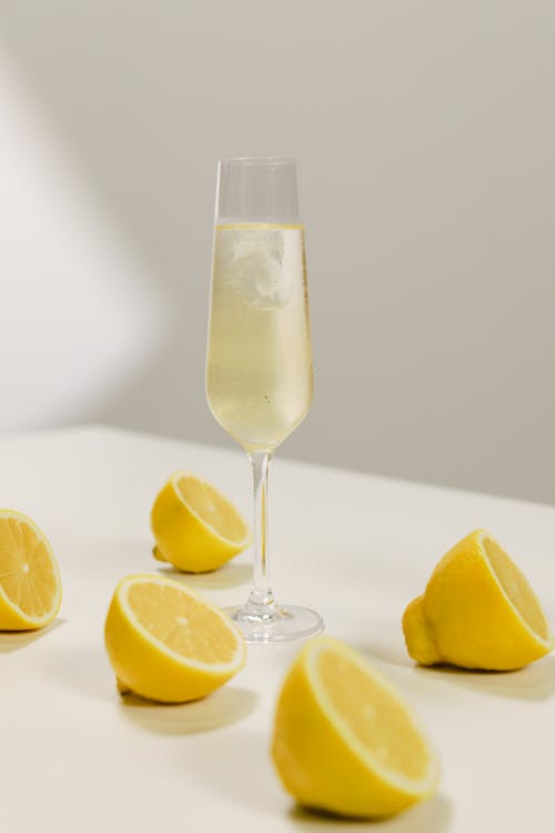 Free A Champagne Glass on the Table Near the Sliced Lemons Stock Photo