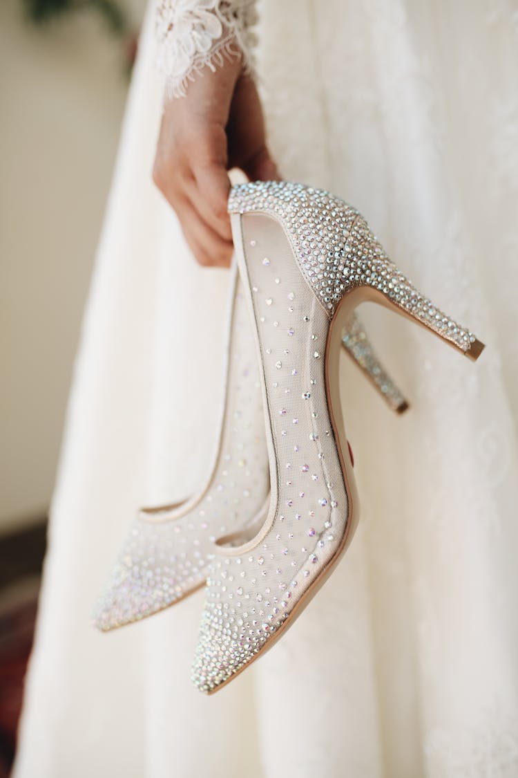 A Person Holding A White Stilettos