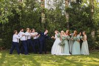 A Bride and Groom Pulling Them by Their Bridesmaids and Groomsmen