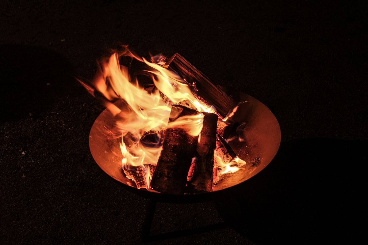 A fire burning low on the ground - Living Sacrifice