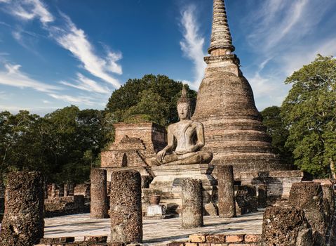 Serene Buddha statue at ancient Sukhothai Historical Park, Thailand, showcasing spirituality and history.