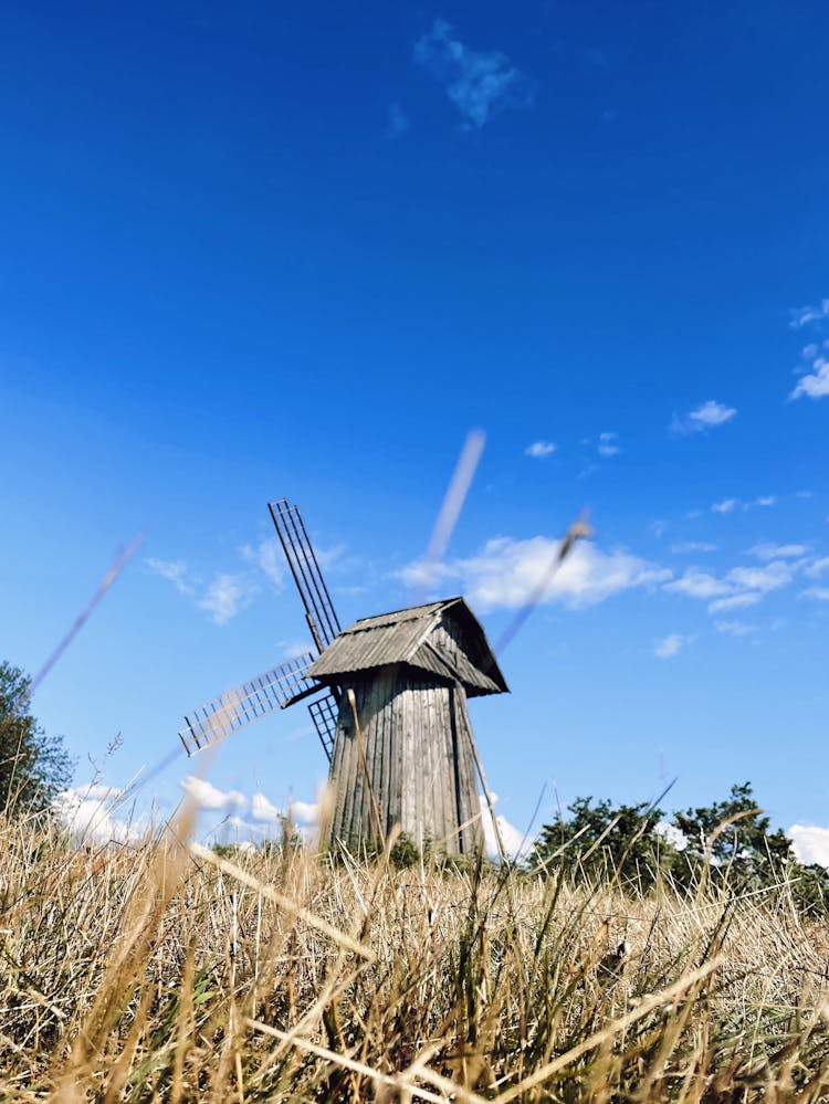 Wooden Windmill Under Blue Sky