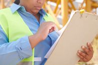 Boy in Blue and Yellow Polo Shirt Holding White Tablet Computer