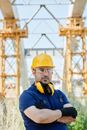 Man in Blue and Yellow Jacket Wearing Yellow Hard Hat