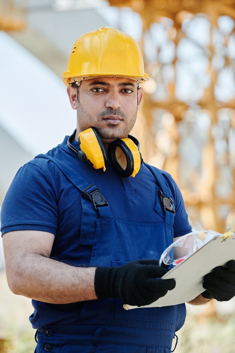 Man In Blue Uniform And Yellow Hardhat