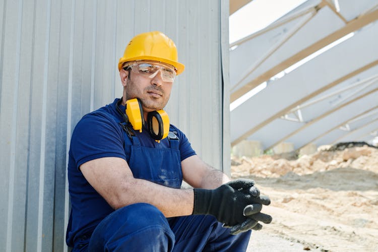 A Man In Blue Shirt Wearing A Yellow Hard Hat