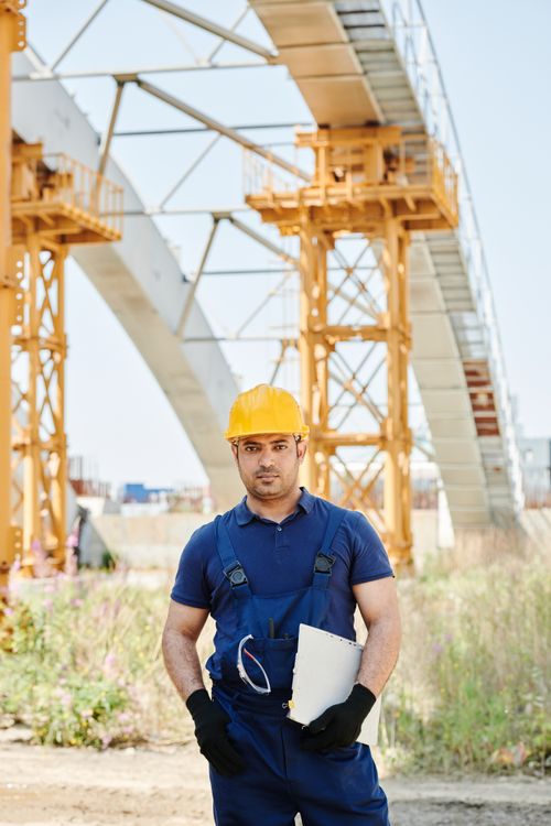 Safety supervisor reviewing corrective action documentation at industrial worksite