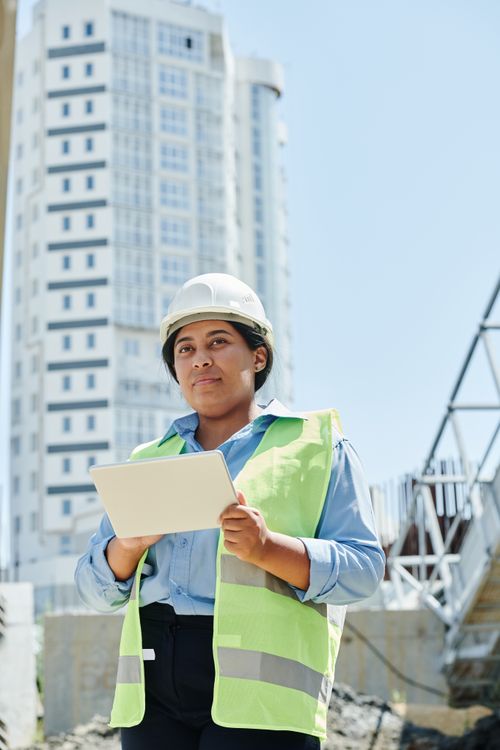 Woman in protective gear managing a construction site