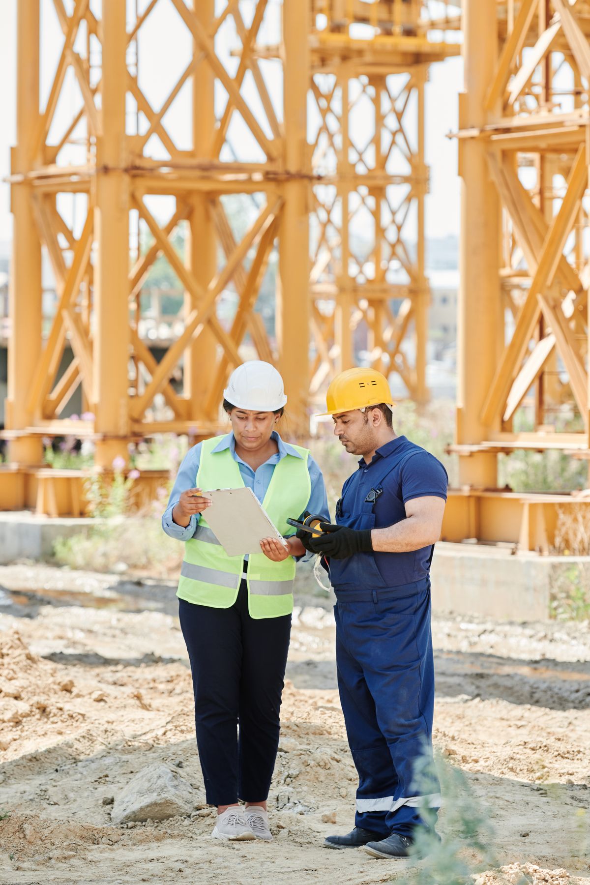 Two construction professionals discussing project plans on site