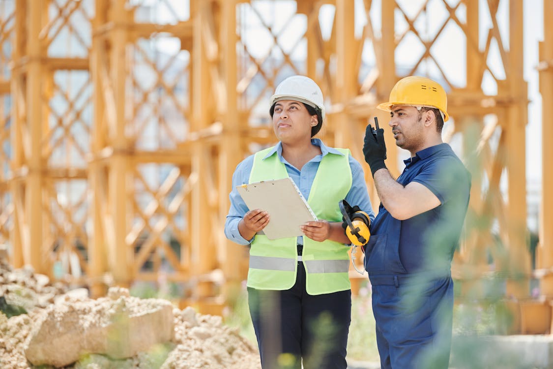 Free A Man and a Woman in a Construction Site Stock Photo