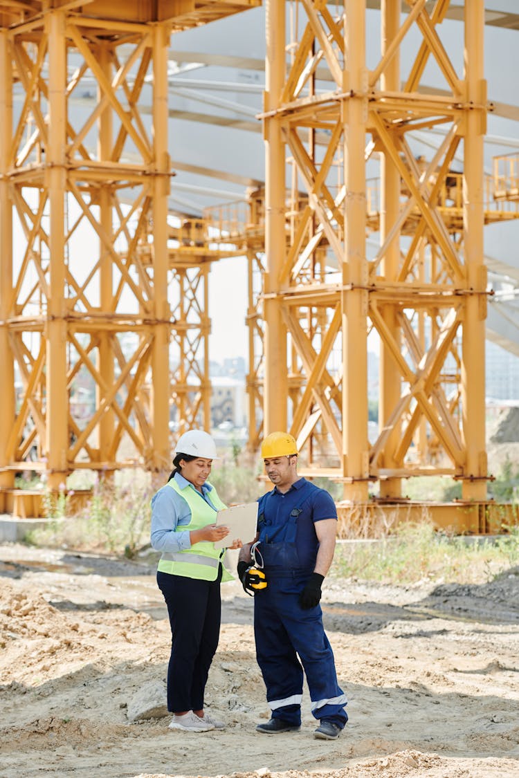 A Man And A Woman Wearing Personal Protective Clothing