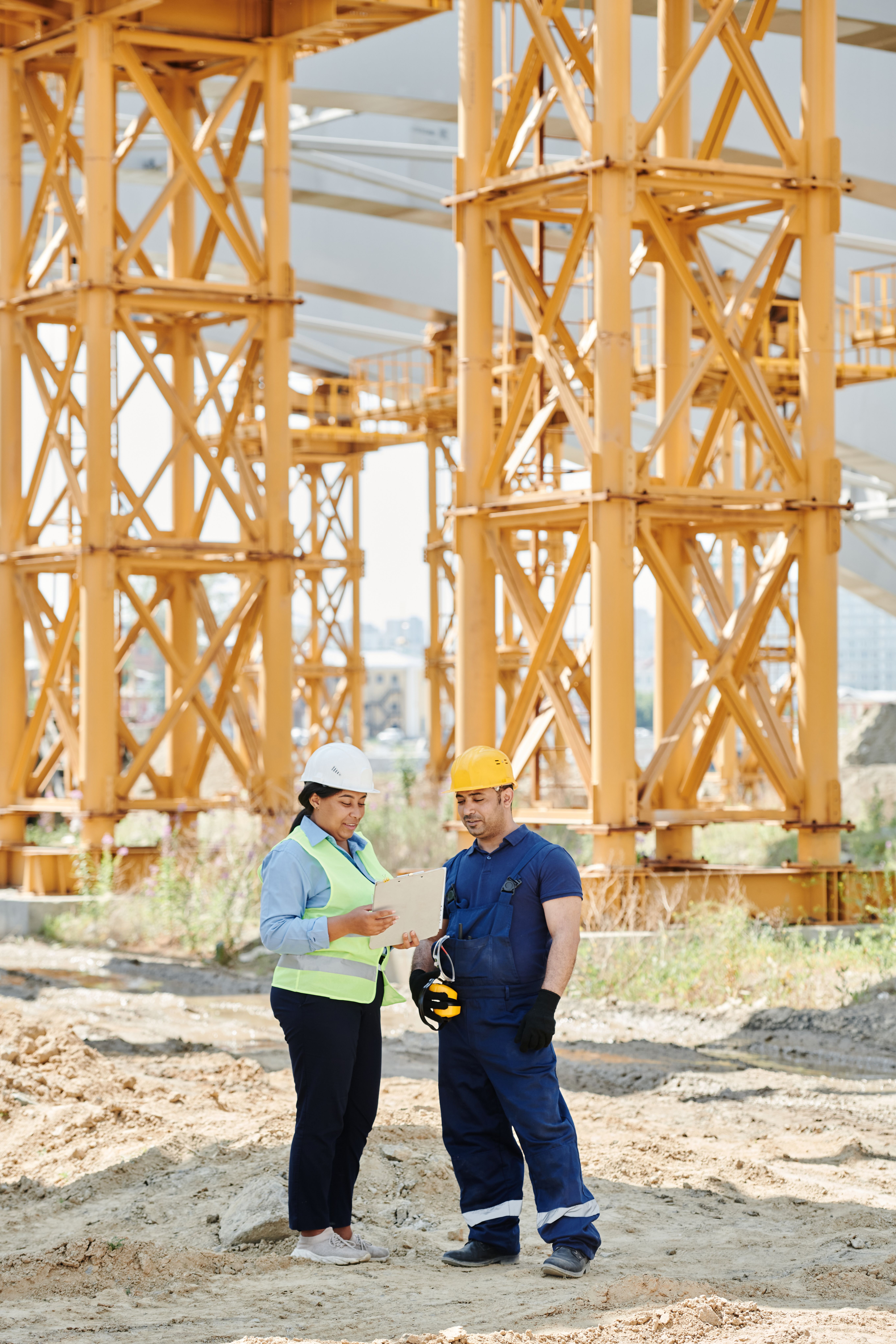 Do You Need a QBCC Licence for Fencing? Rules, Exemptions & Licence Classes Explained 6 Two construction workers examining plans and paperwork on site