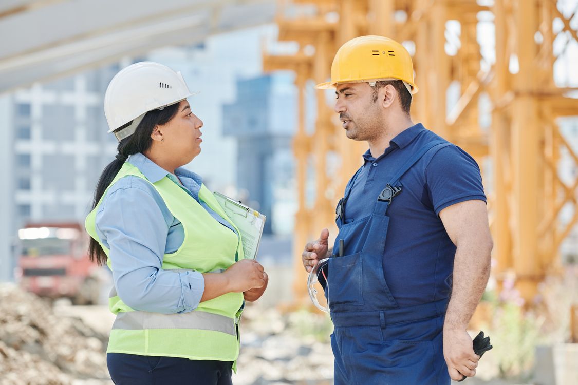 Construction professionals discussing project execution on site