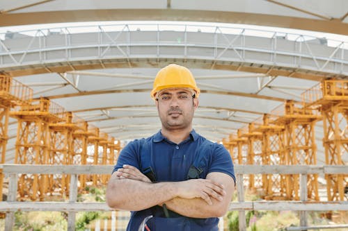 A Man Wearing a Blue Polo Shirt and a Hard Hat