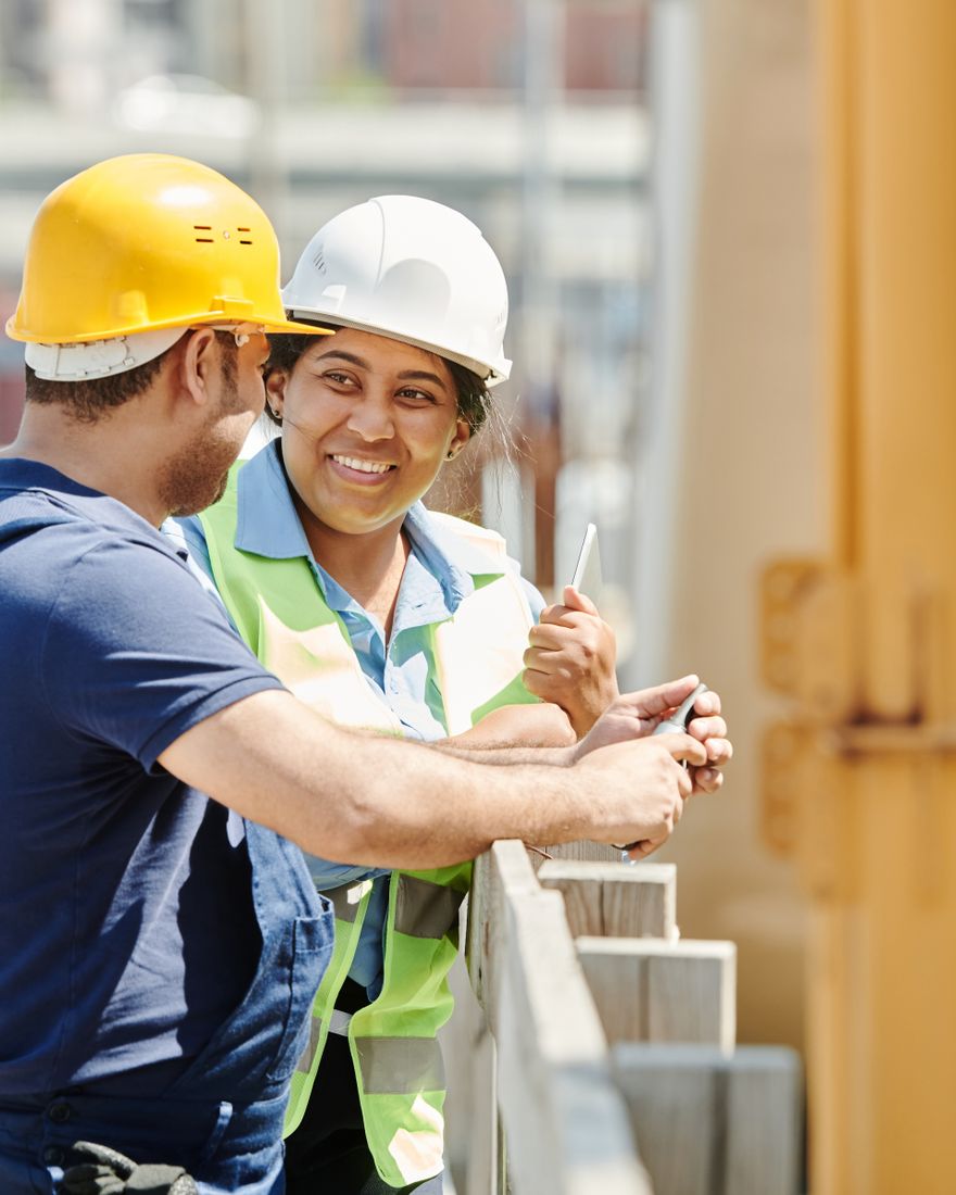 A builder and a colleague talking through the job on site