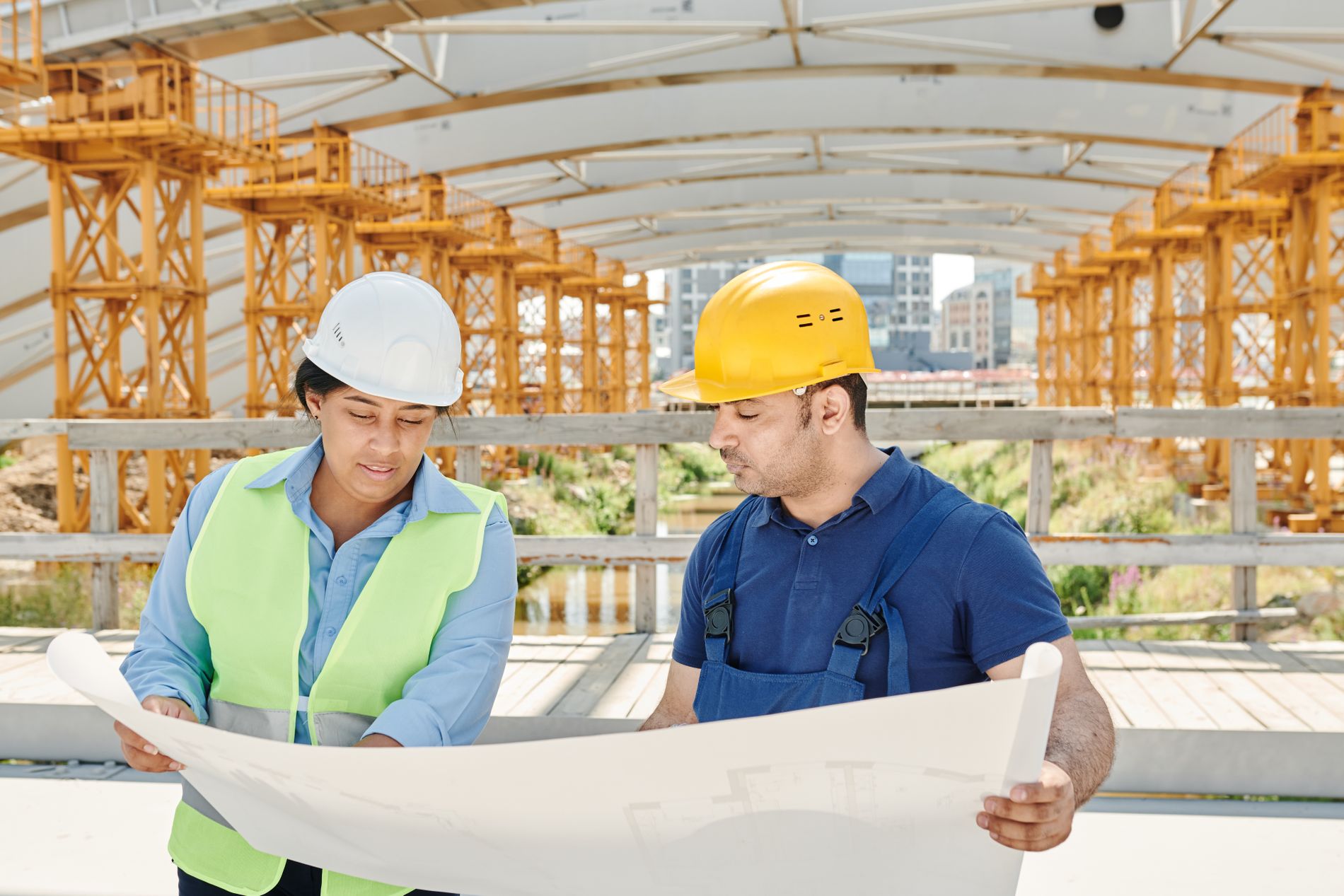 An engineering team reviewing drawings together on a construction site