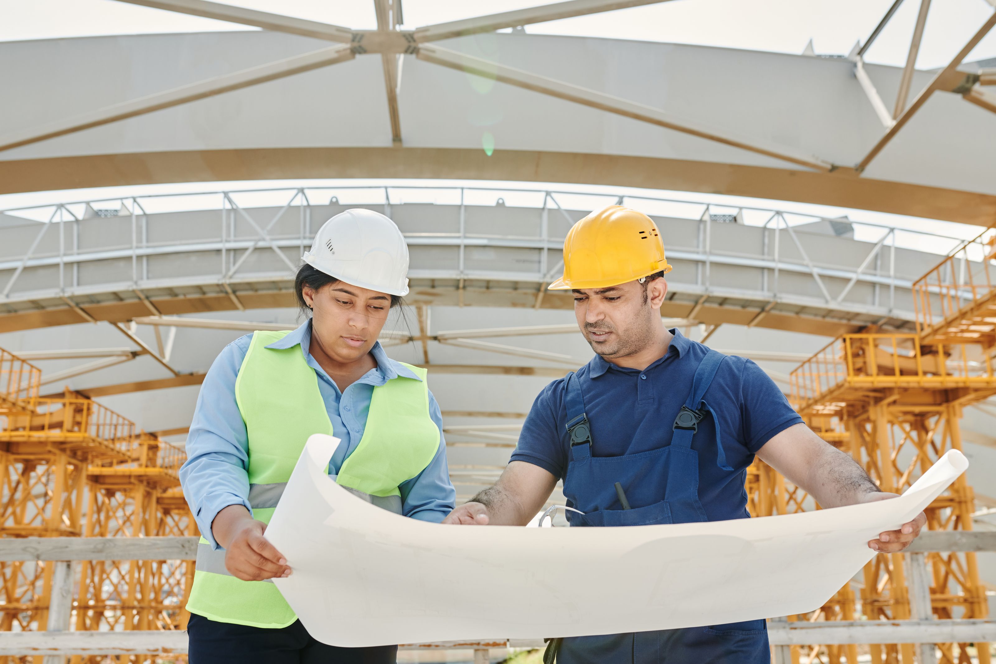 Engineers reviewing site blueprints