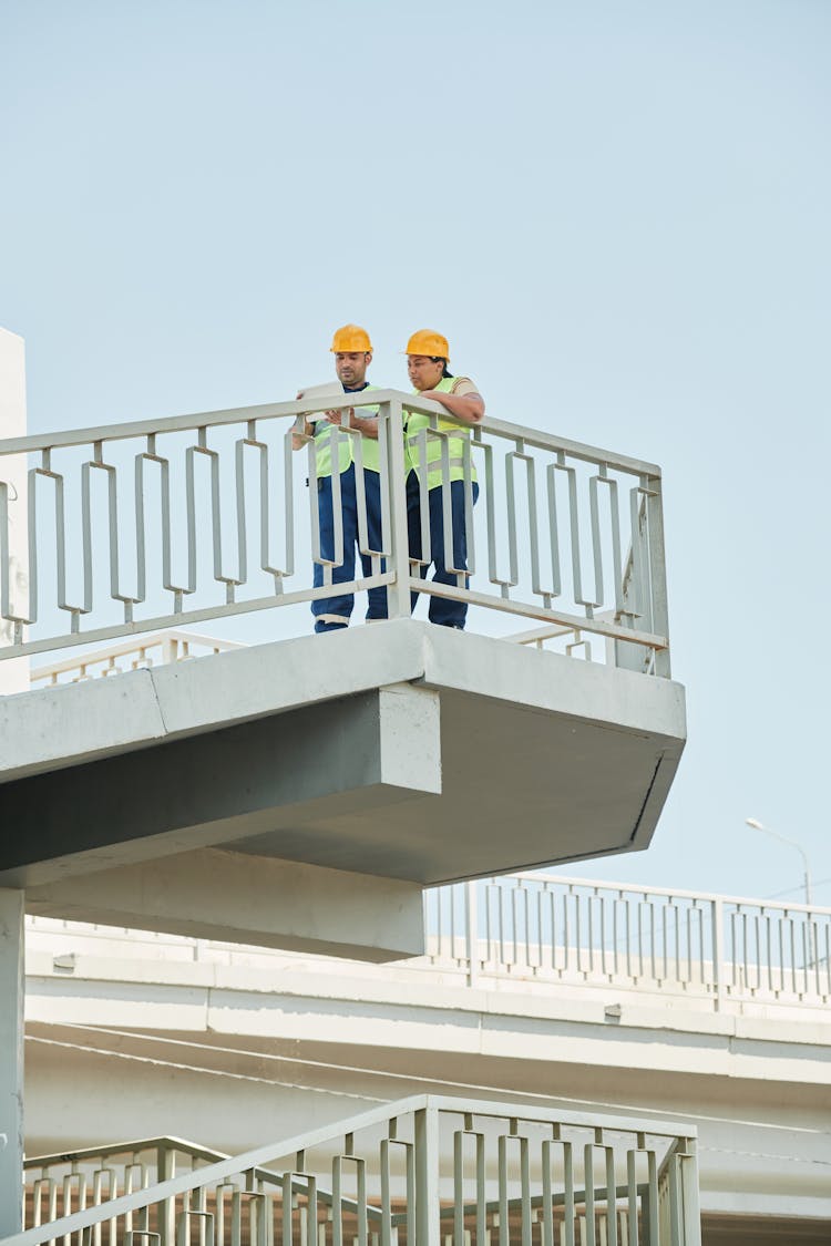 Construction Workers Standing At A Balcony