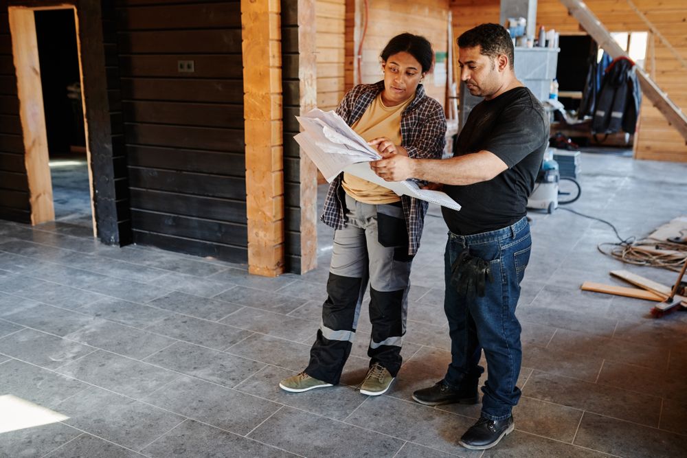 Project team reviewing construction blueprints on site