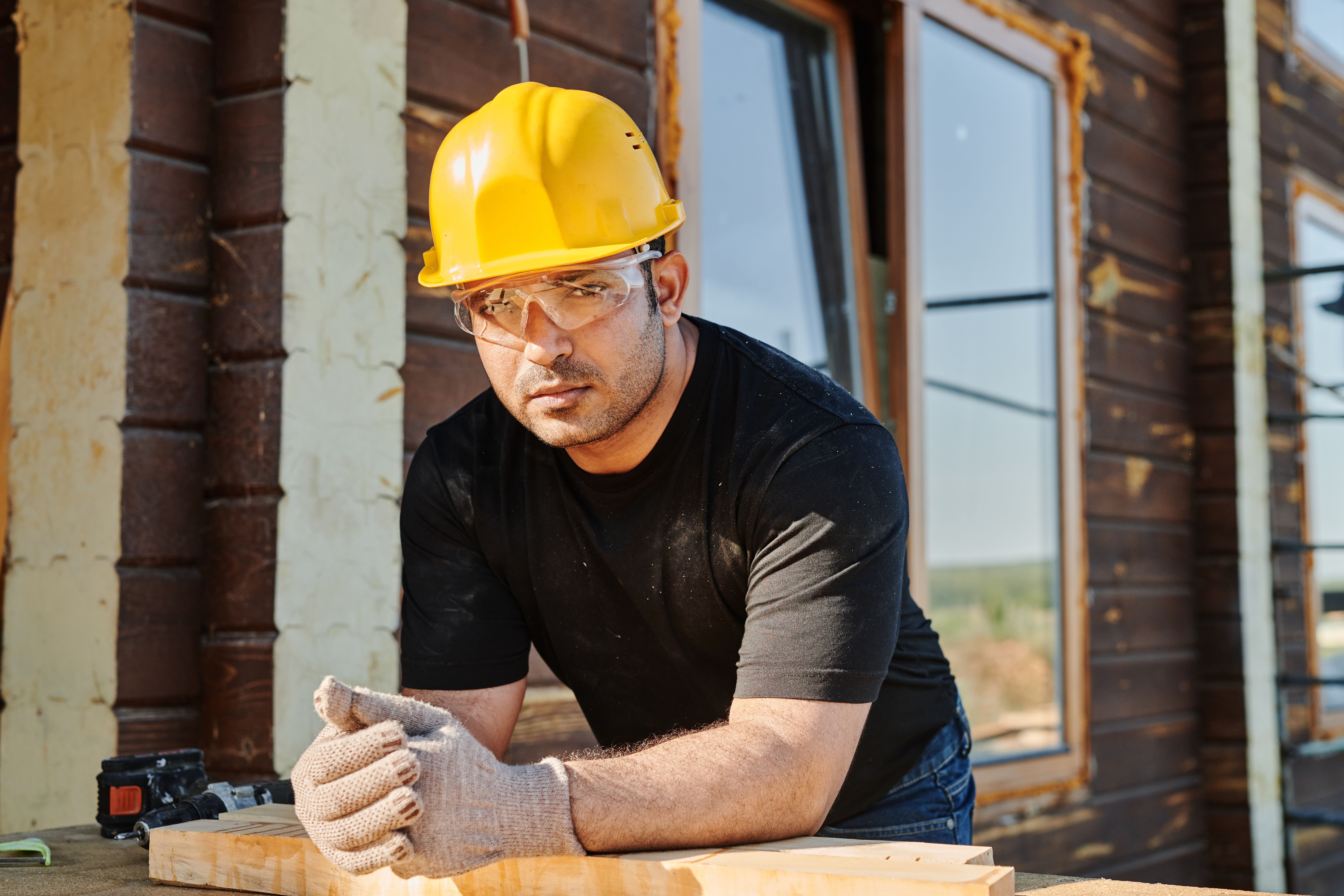 Trade Contractor Licence: What It Is, When You Need It & How to Apply Smarter 4 Carpenter using a power drill on a wooden plank