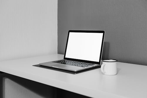 A Laptop and a Cup on a Desk