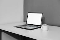 A Laptop and a Cup on a Desk