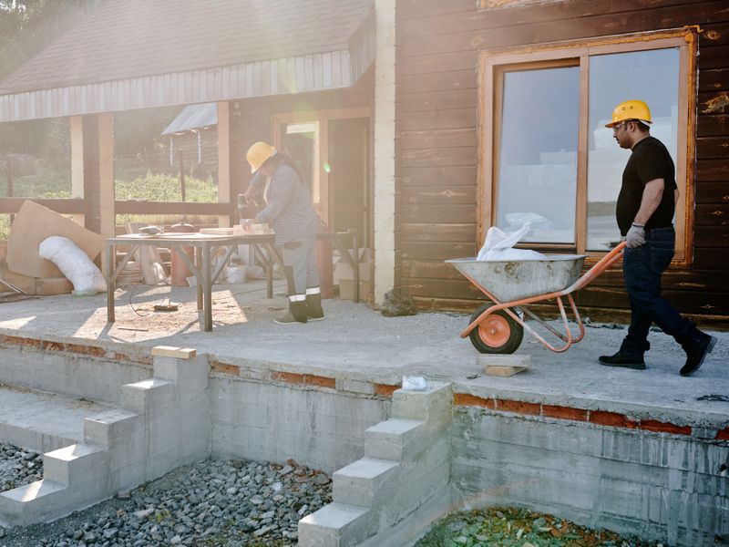 Builders laying blockwork on site
