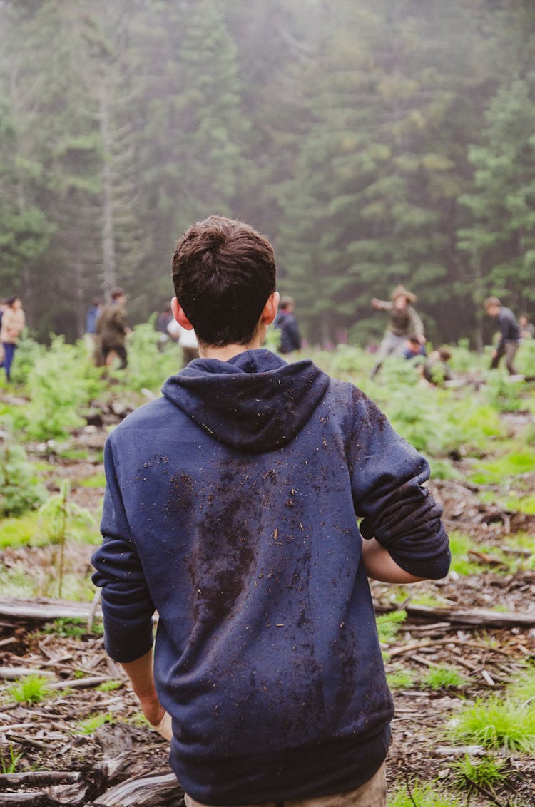 A Man With A Dirty Blue Hoodie