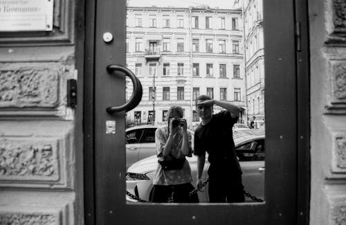 A Photographer Taking Photo of Their Reflection from the Door