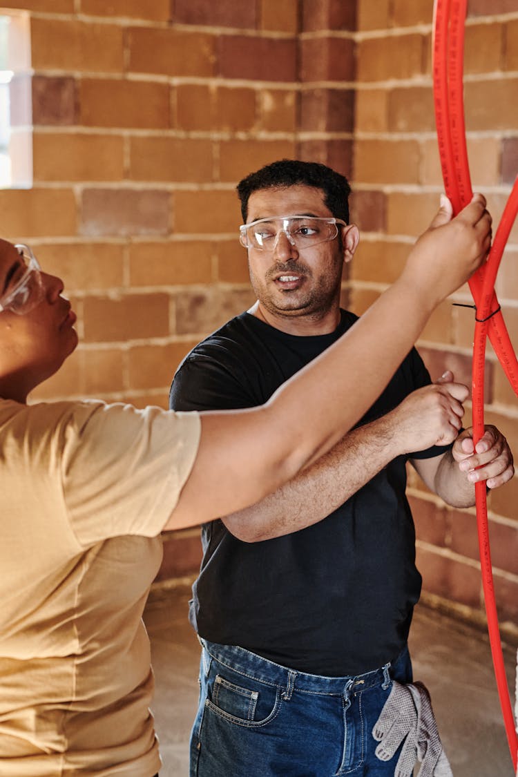 Man And Woman Working On Construction Site