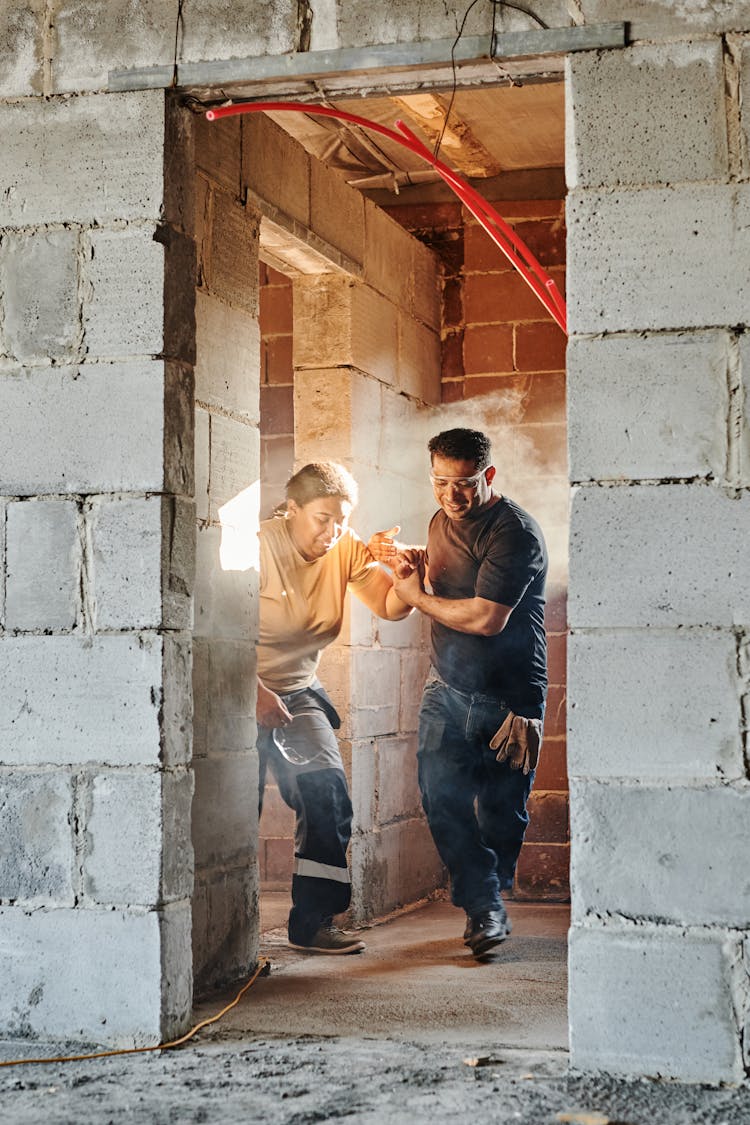 Construction Workers Walking Out Of A Doorway