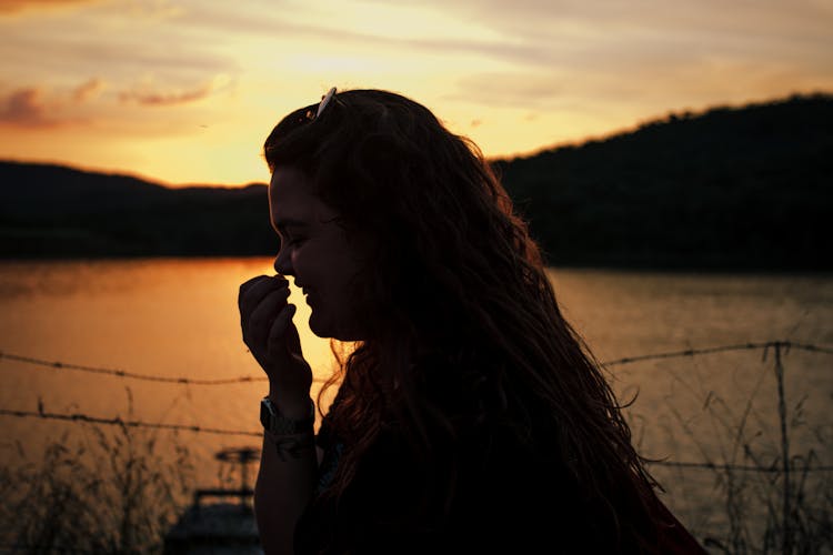 Silhouette Of Side Profile Of Woman Laughing During Sunset