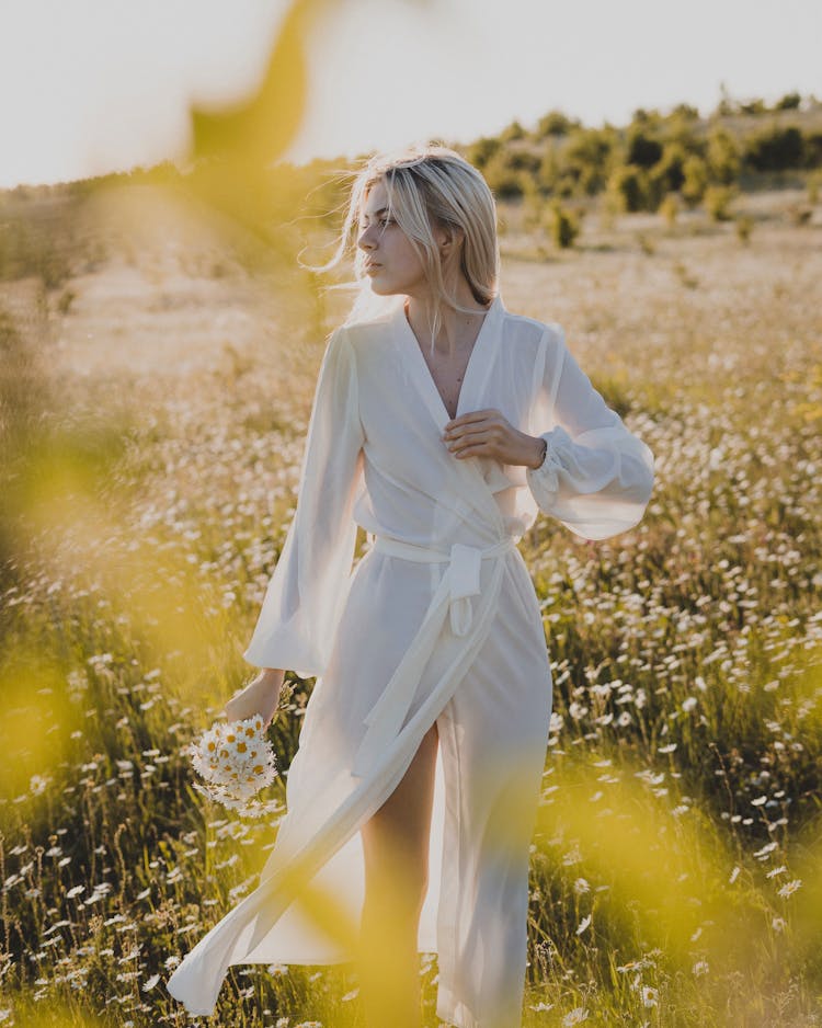 A Woman Standing In A Field Of Oxeye Daisies 