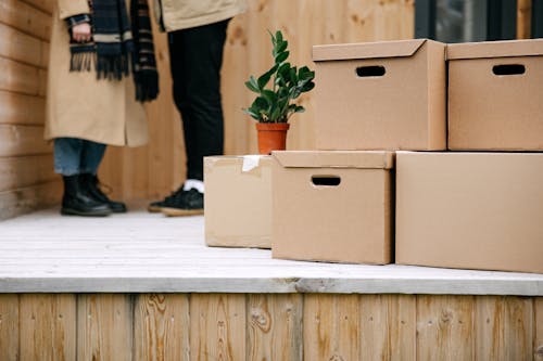 Free Brown Cardboard Boxes on Wooden Floor  Stock Photo
