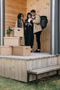 Woman in Black Coat Standing Beside Brown Cardboard Box