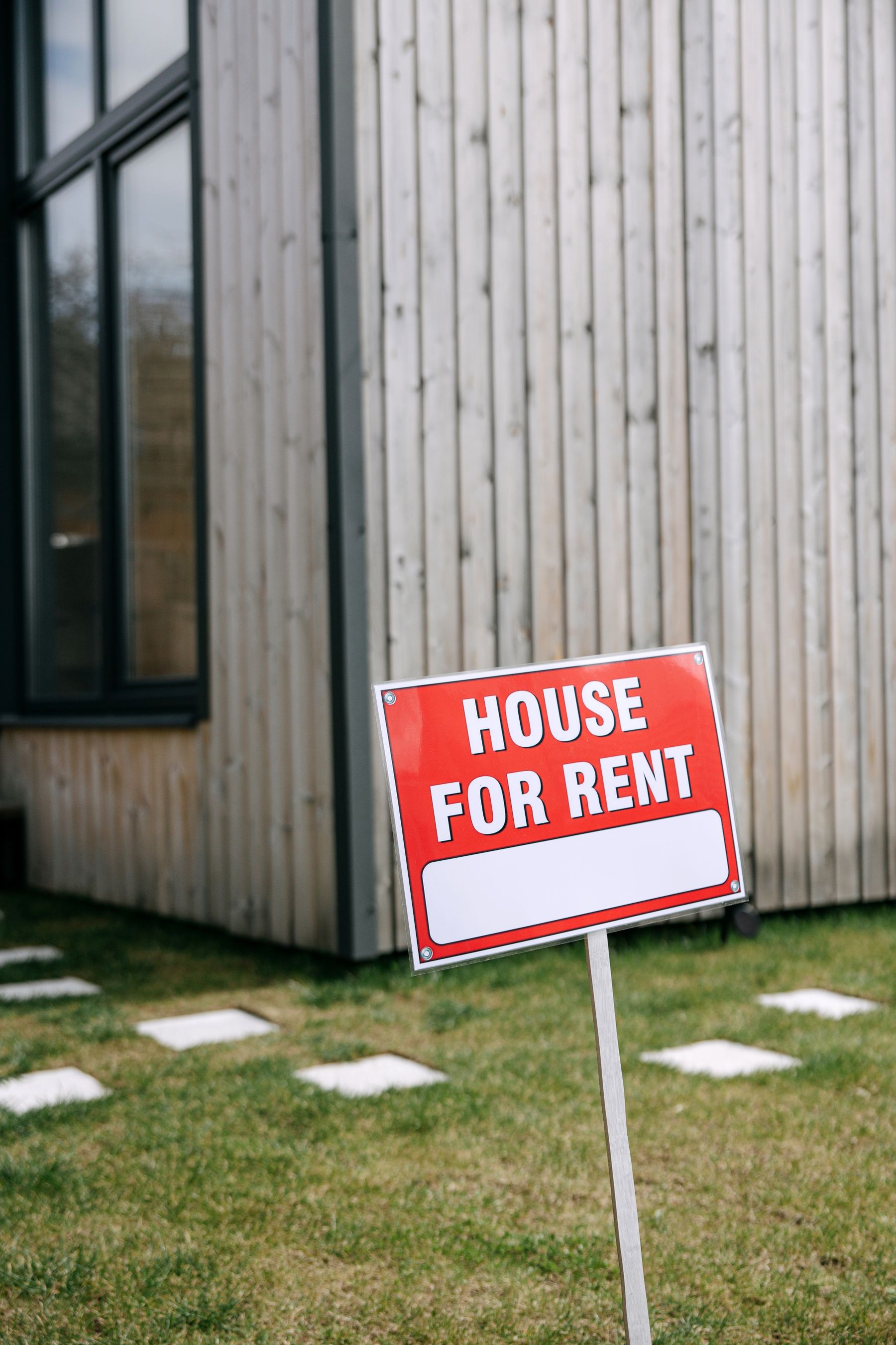 House for rent sign in front of a residential property