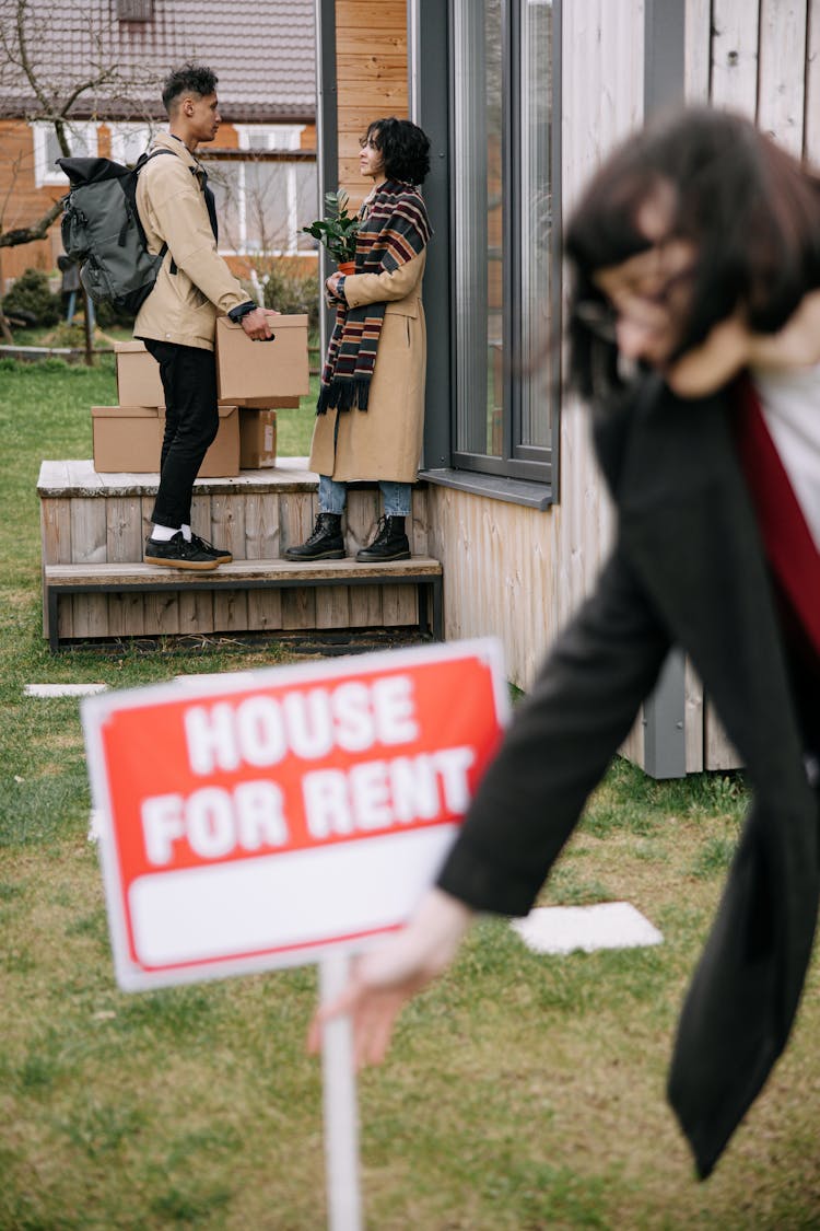 Woman In Black Coat Removing The Signage 