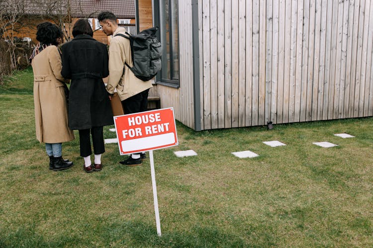 Back View Of People Standing Near The Signage 