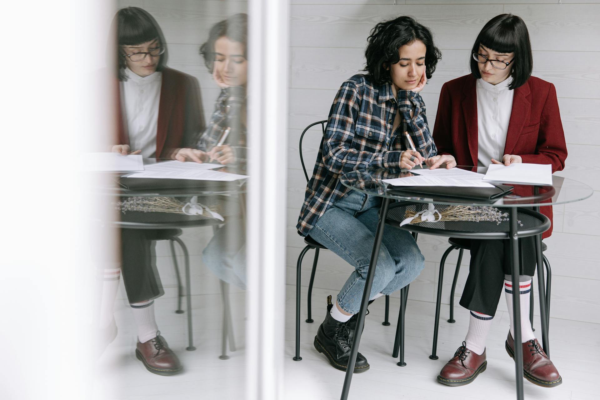 A Woman Signing a Document with Her Real Estate Agent