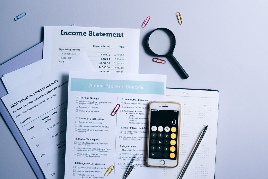 Home Bakery Insurance and Liability: What Indian Home Bakers Need to Know 2 An organised desk with tax documents, a checklist and a calculator, representing the records a home bakery must keep.