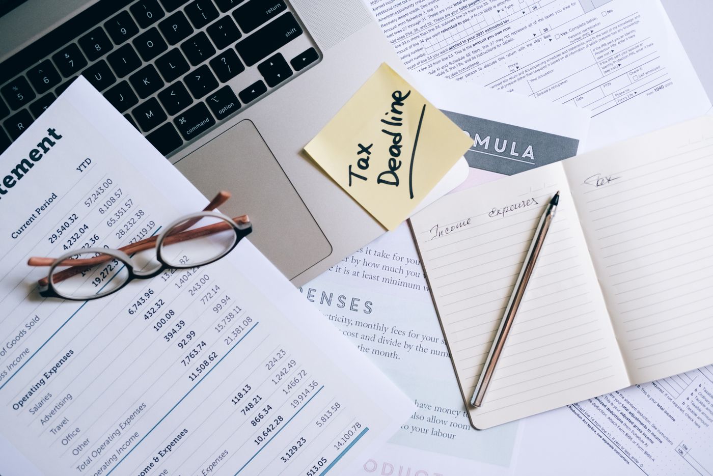Laptop, notebook and financial documents prepared for business administration